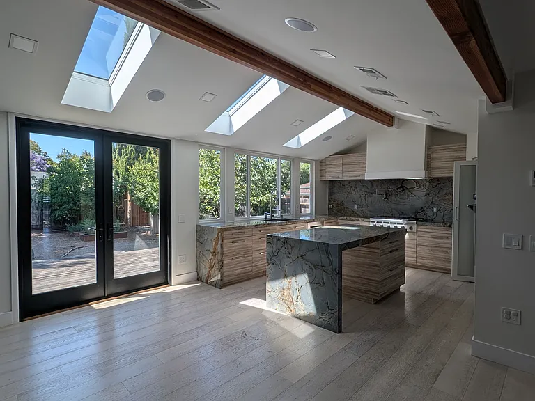 Dining area adjacent to the kitchen. Very airy, grand and well lit. Kitchen has built in speakers (will require you to add your own system).