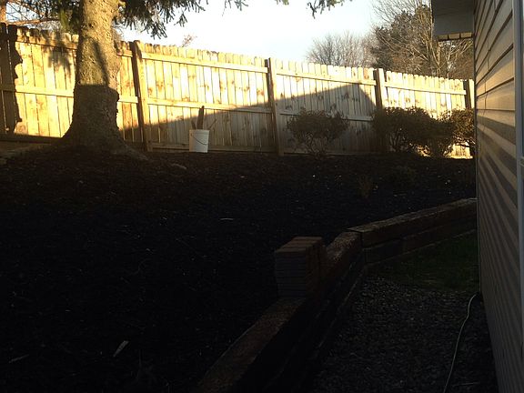 Back of house retaining wall with privacy fence