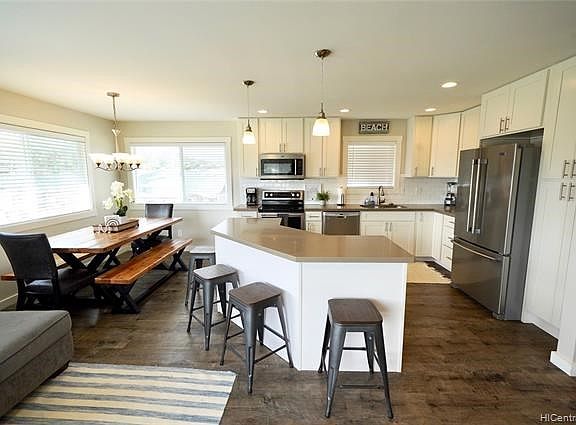 Upstairs kitchen and dining room area with stainless appliances and granite countertops.  All furnishings included.