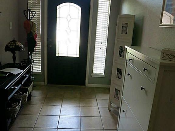 Beautiful entry door, high ceilings and tile floors