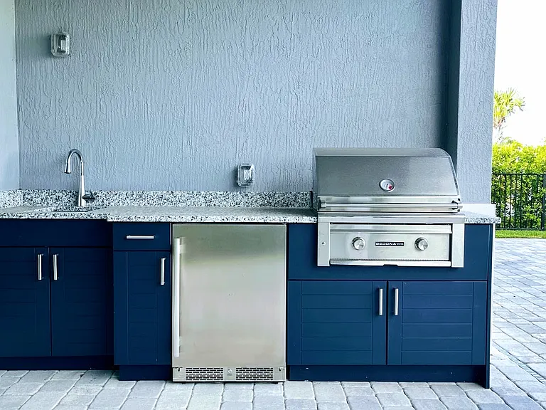 Builtin outdoor barbecue with fridge and sink.
