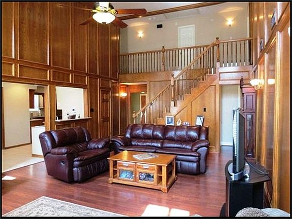  Family room with high ceilings, laminate wood floors, recessed can lighting and ceiling fan.