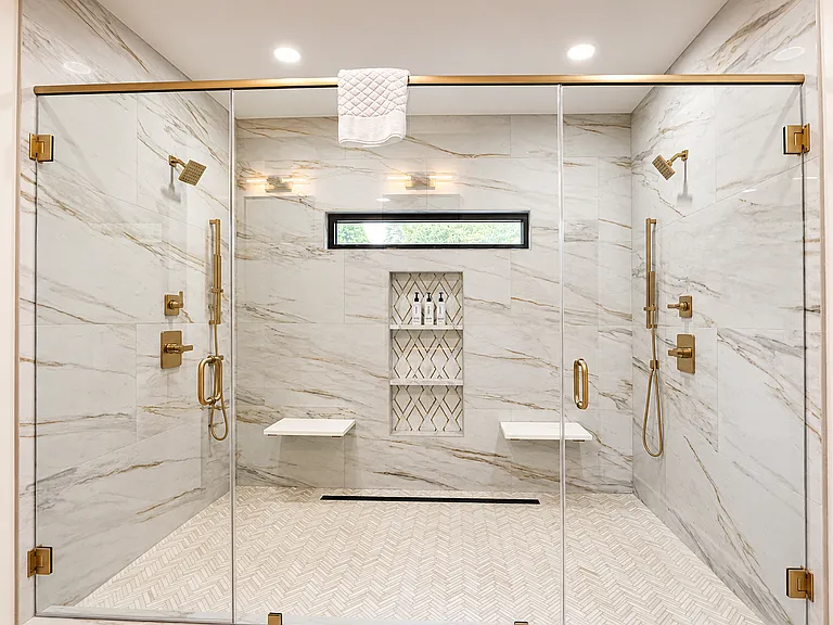 Step inside luxury for a showering experience reminiscent of a waterfall, spa. Spa-inspired primary bathroom in the Edgewood Suite featuring luxury, large walk-in shower with rainfall & dual shower heads & premium Apotheke bath products.