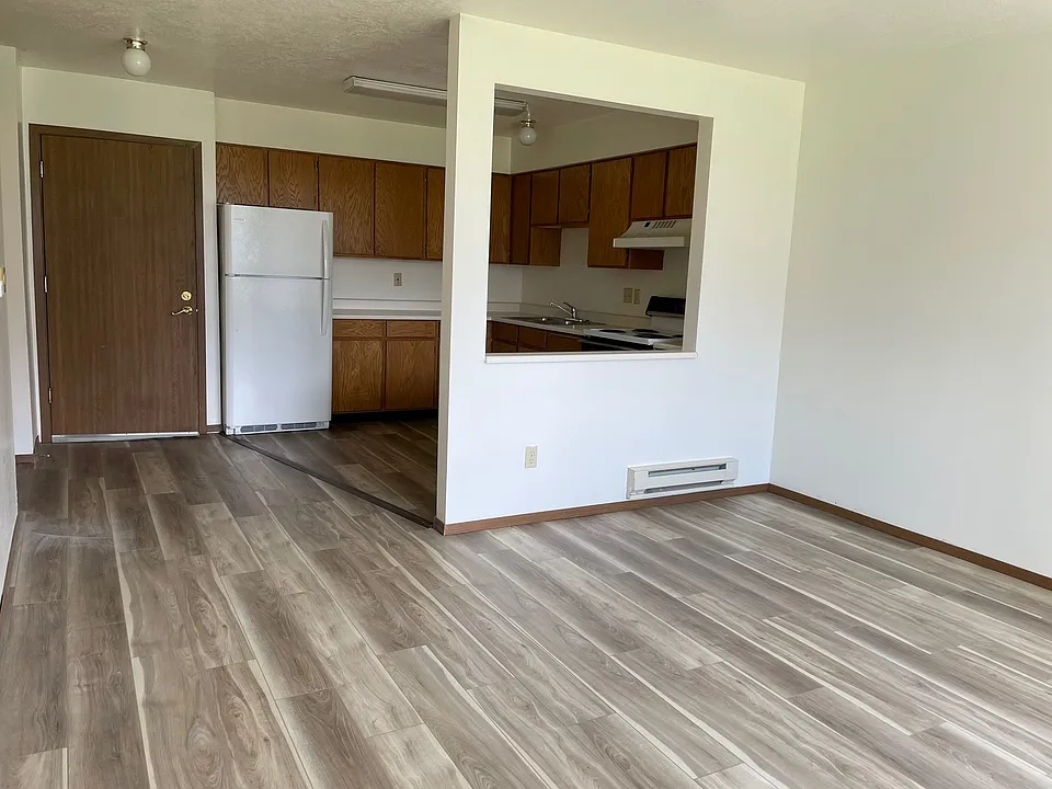 In unit view of entrance and kitchen from living room