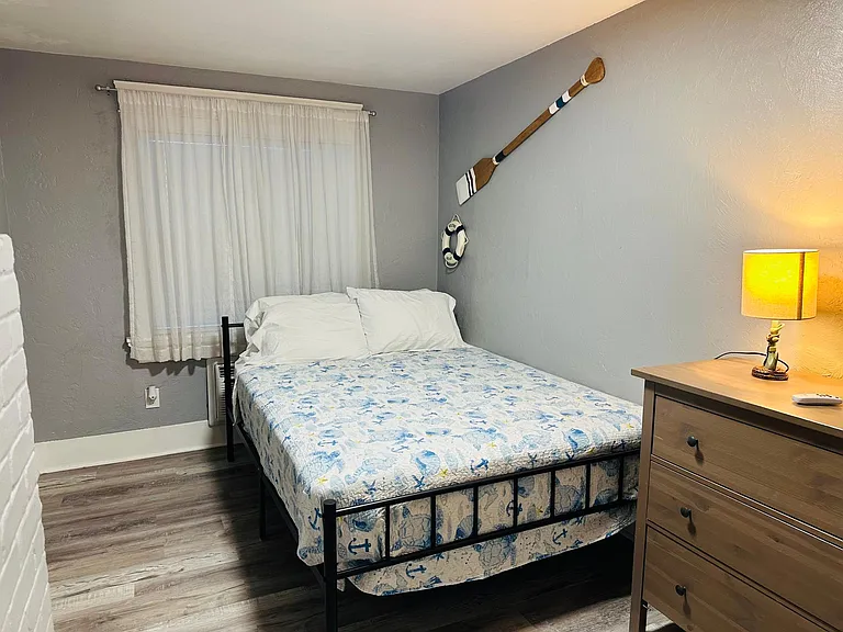 Bedroom with a queen size bed and 12 inch new mattress and tv.