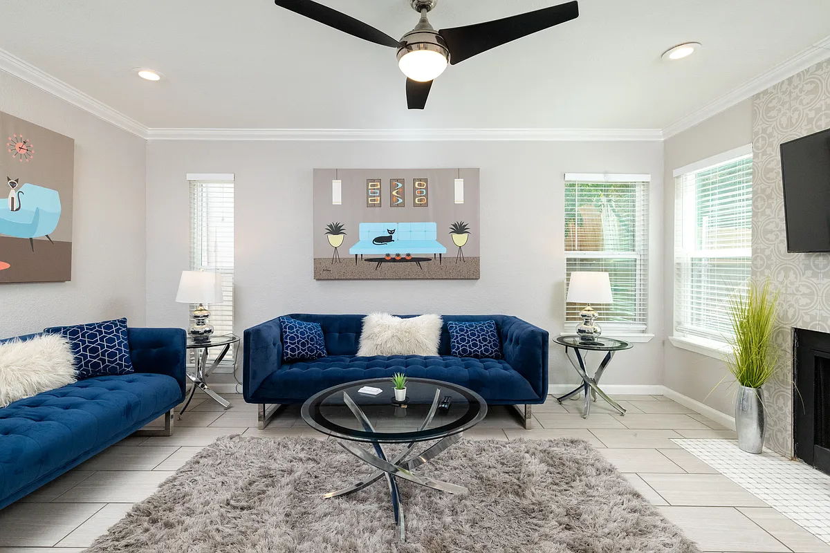 Spacious living room with couch, fireplace and flat screen TV with natural light. - 2213 Park Hill Dr