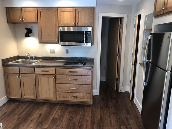 Kitchen with bathroom entry on right.