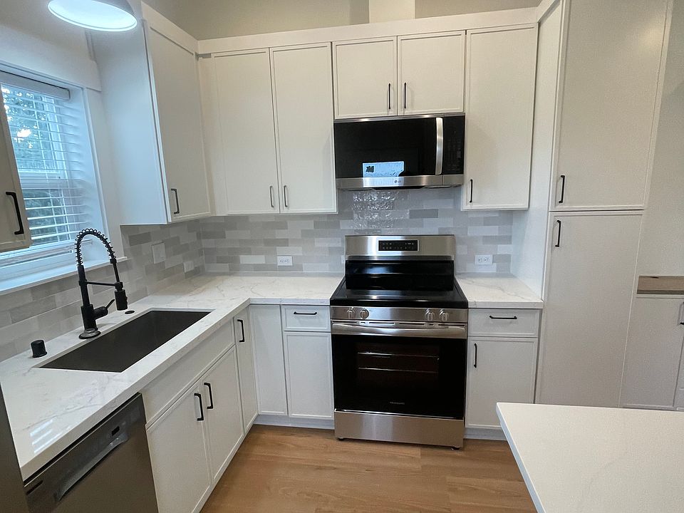 All new kitchen cabinets, counters, tile, floors, and appliances. Large cabinets. Great lighting, 10' ceilings