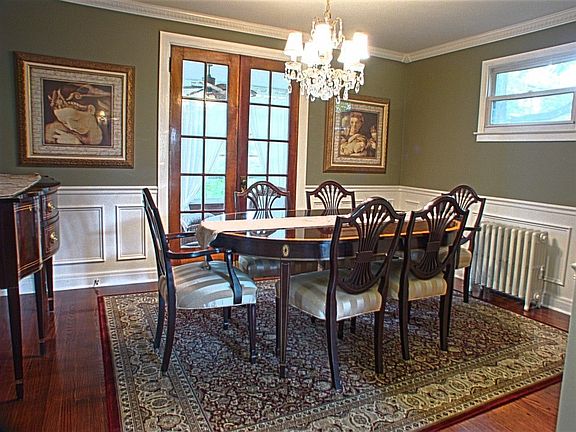Formal dining room with french doors to 3-season room