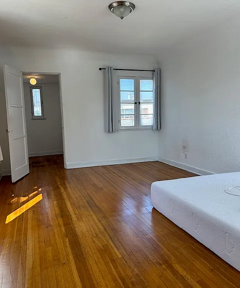 Master bedroom with windows facing south, and entry to the walk-in closet
