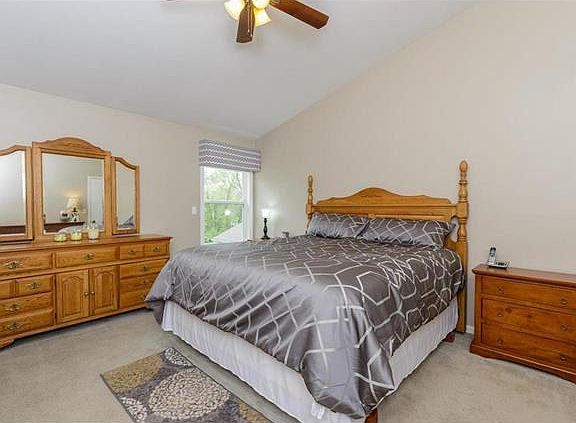 Master Bedroom Suite with vaulted ceiling, walk-in closet & ceiling fan.