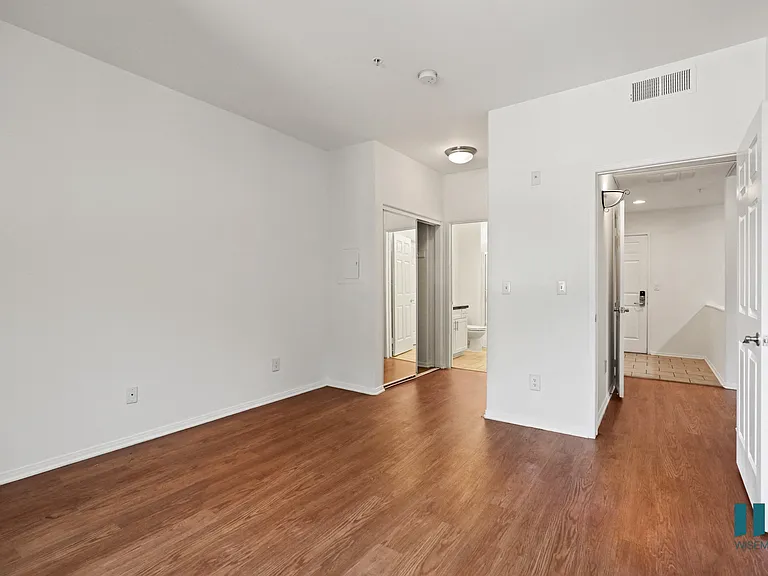 Bedroom with Bathroom, Mirrored Closet, and Vinyl Flooring