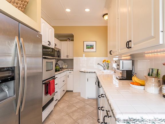 Galley kitchen with stainless steel appliances and double ov
