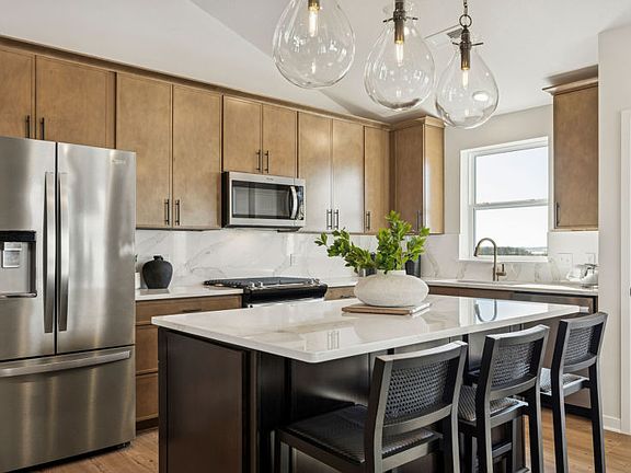 Modern kitchen with sleek finishes and a spacious central island.