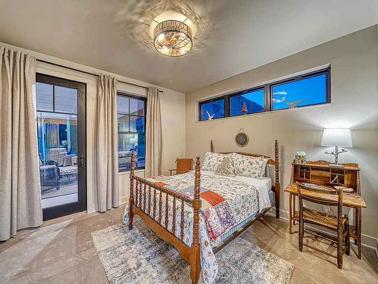 The Chalk Cliff Room with full bed, closet, smart tv, ceiling fan, and patio access. Postcards available in the writing desk, so send your friends a card and invite them to come stay with you next time.