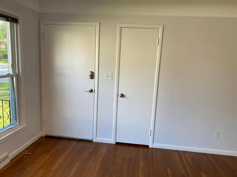 Living Room Facing Front Interior Door and Coat Closet