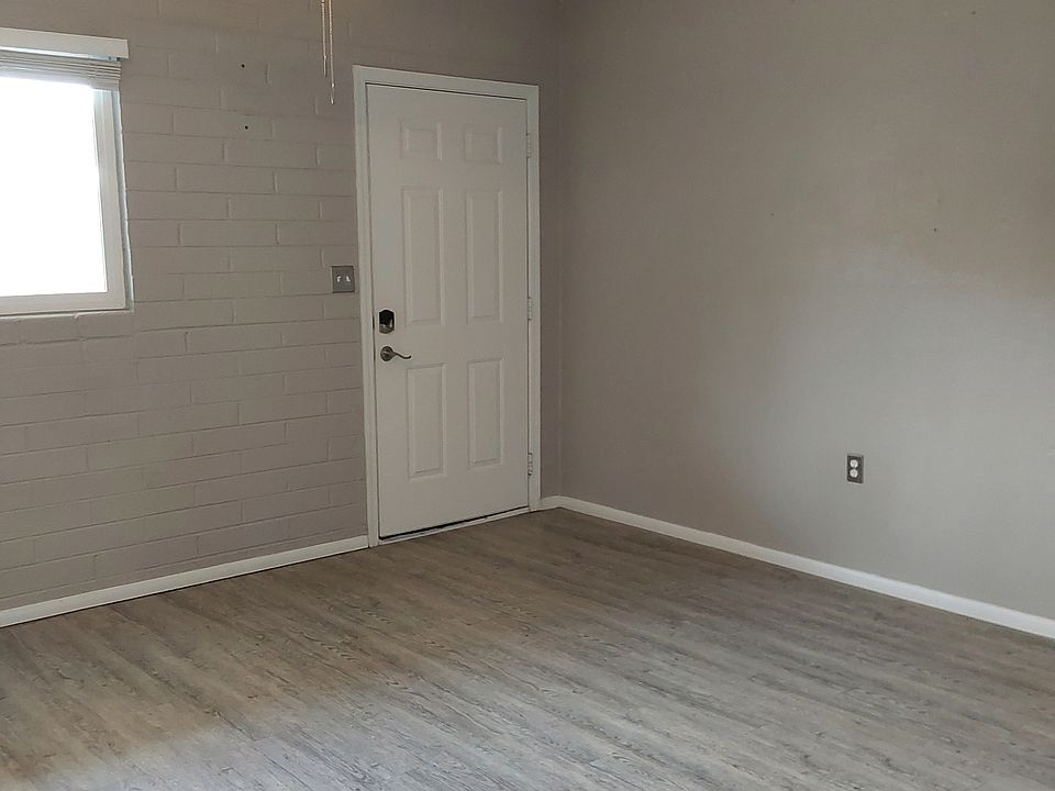 Livingroom features ceiling fan, blinds, and faux wood flooring.
