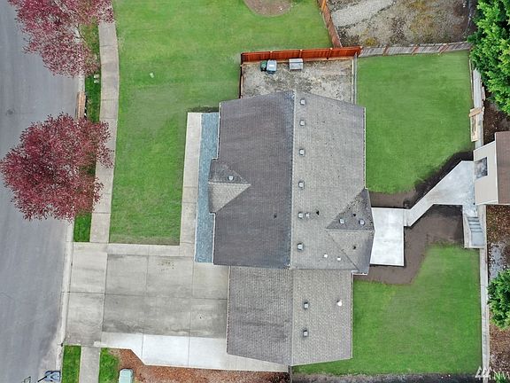 Aerial view of home shows new entertainment sized patio, sidewalks and storage shed!
