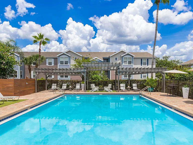 Dive into comfort and sunshine with our sparkling resort-style swimming pool, complete with lounge seating, shaded pergola, and outdoor relaxation areas.