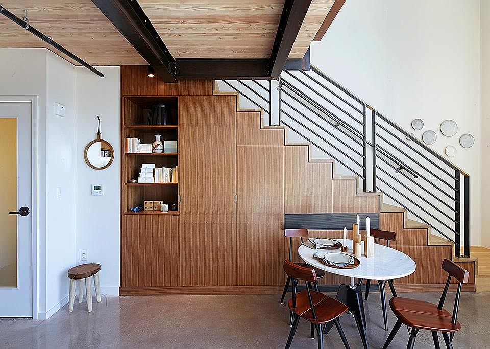 The bookshelf and under-stair cabinets offer ample storage.