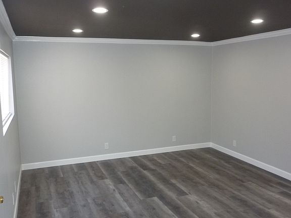 Living room with custom paint, crown molding and recessed lighting with dimmer switch.