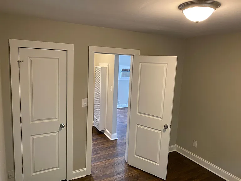 Bedroom looking out towards the living room and hallway