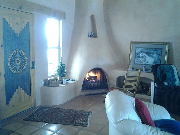 front door, living room w/ kiva fireplace