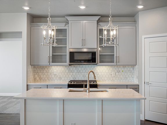 The Primrose s designer decorated kitchen spills into the dining room allowing for an open feel.