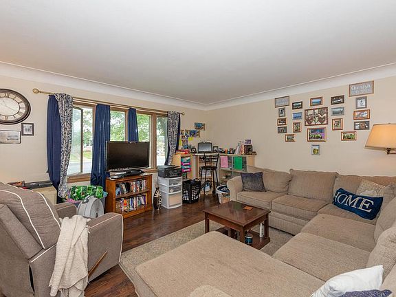 Front living room area with large window and new laminate flooring.