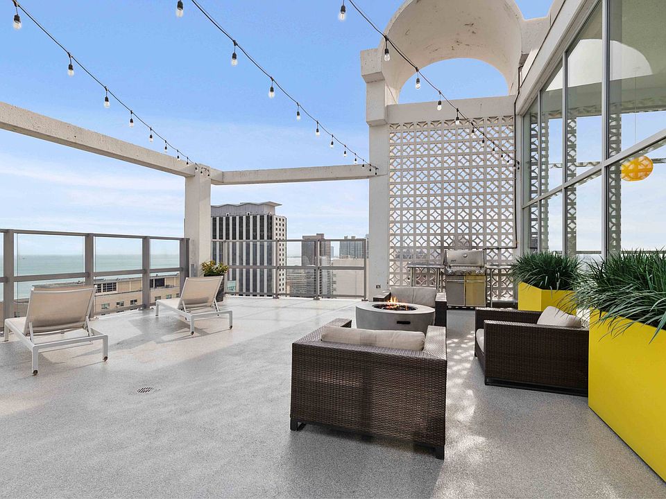 Rooftop sun deck with fire pit and grilling station