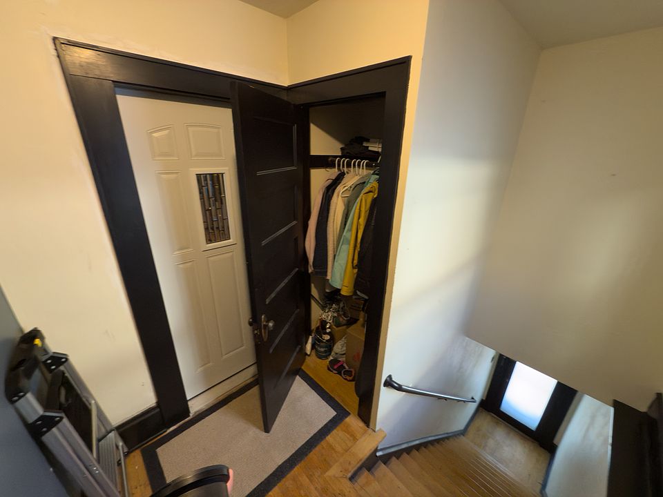 Private entrance to unit with extra security door and storage closet.