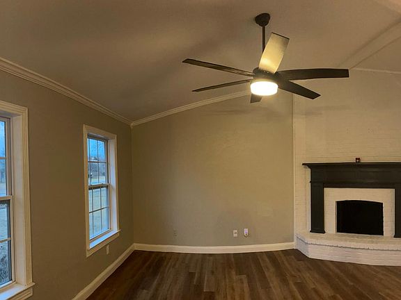 Freshly painted living room with painted brick fireplace and Sherwin Williams Cyberspace mantle