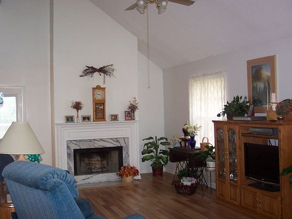 Greatroom w/vaulted ceiling and wood floors.