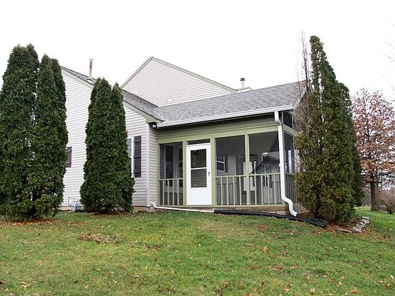 Mature trees and screened porch with access to kitchen and breakfast room area.