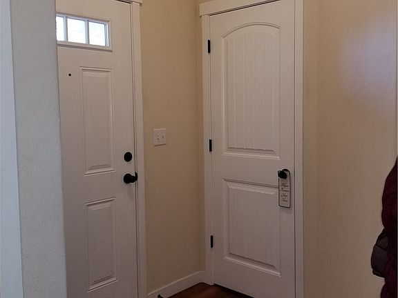 Hardwood floors at entry, into hallway, kitchen, and dining room.