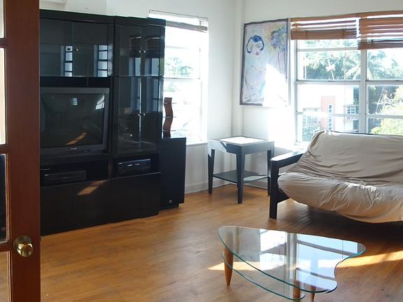 another view of the living room. Is partially furnished.