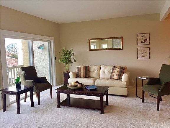 Large living room with fireplace & wrap around balcony & views.