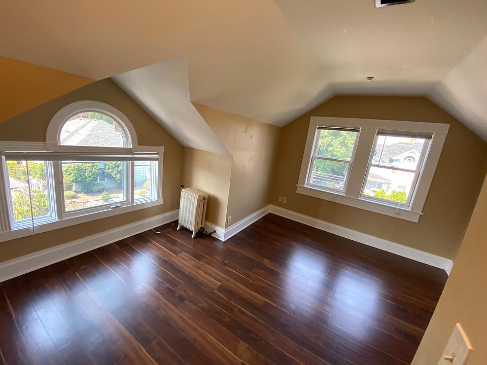 Bedroom with flower boxes outside of windows.
