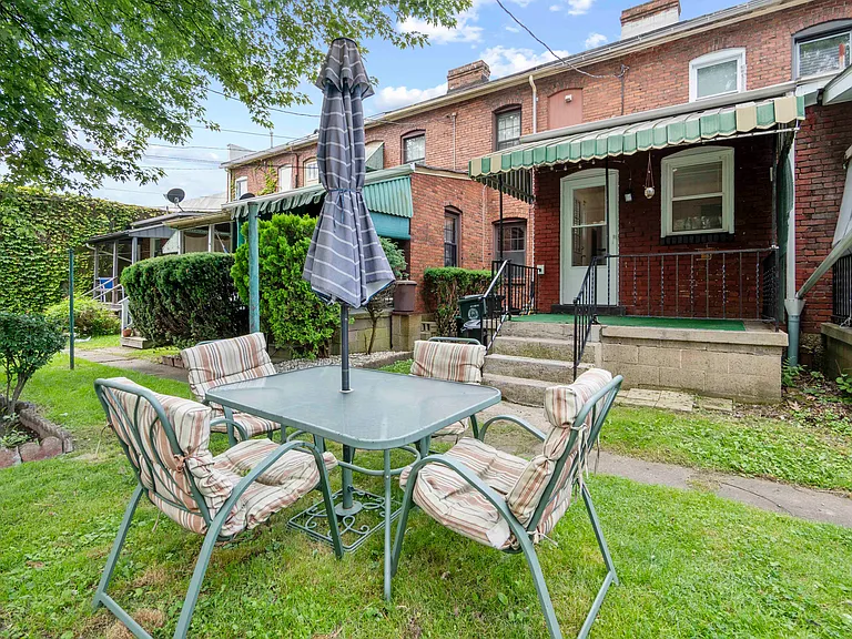 Yard with outdoor table and chairs included. Covered back porch!