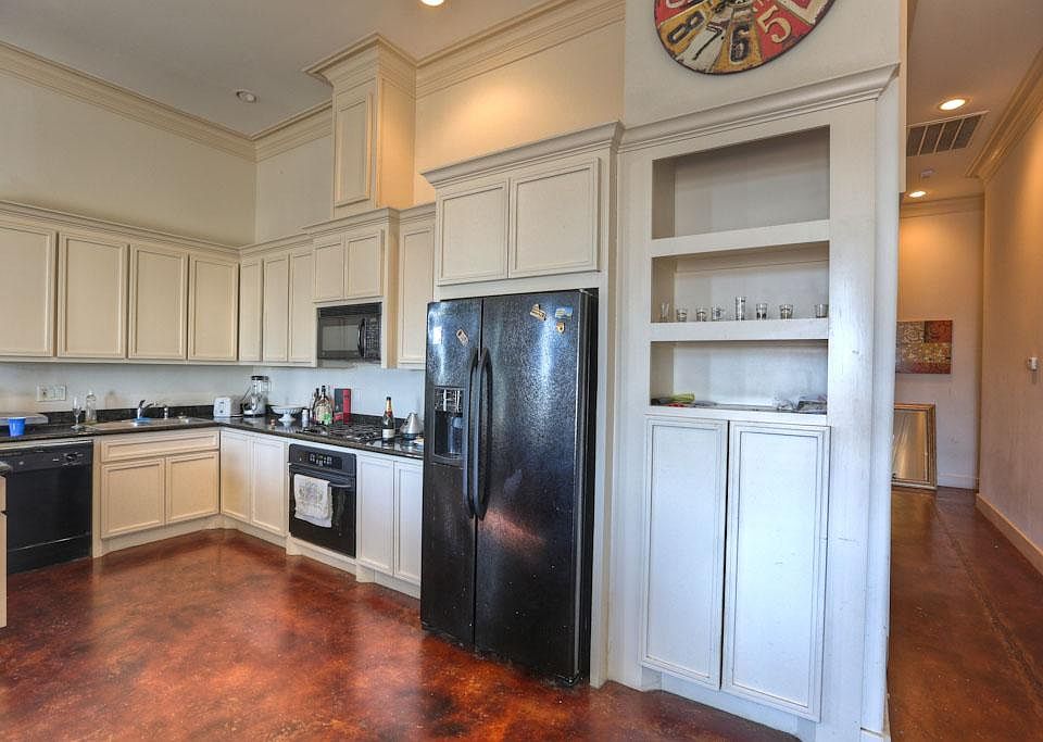 Great Kitchen features custom cabinetry, granite counters, stained concrete floors.