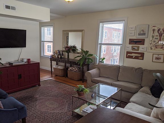 Sunny Living Room with large windows & high ceilings