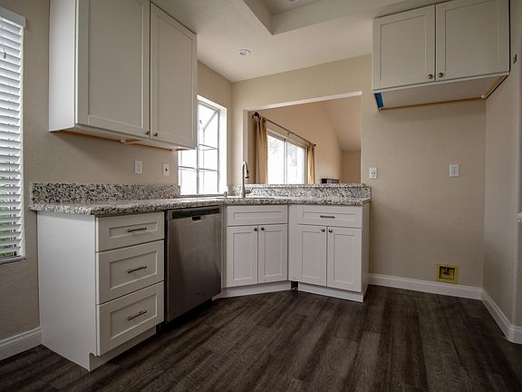 Kitchen with new floor, cabinets, countertop, new Samsung stove, microwave, and dishwasher and disposal (Tenant provides their own refrigerator)