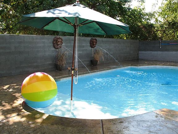 Inviting Pool with fountains & stamped concrete.