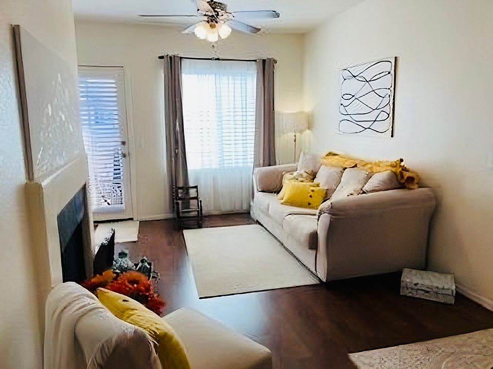 Living room with access to balcony overlooking gardens and pool
