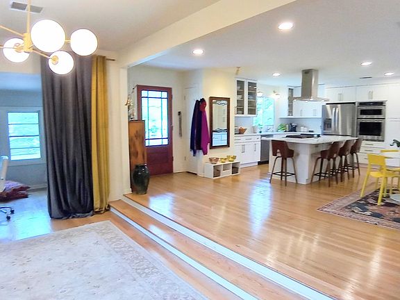 Natural light pours in from all directions in this open concept, modern home. Expand or partition off den for office space or oversized dining and play area.