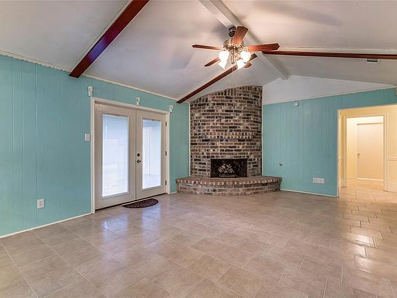 View of the Living Room from the kitchen dining area. The door to the left opens to covered patio.