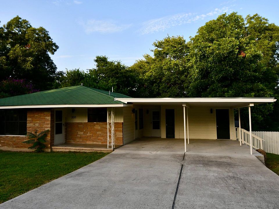Large driveway, covered carport, and street parking are available.
