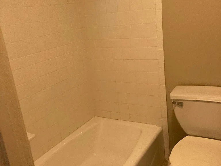 Full hall bathroom featuring a tub/shower combination and a functional layout, conveniently serving the second bedroom and main living areas.