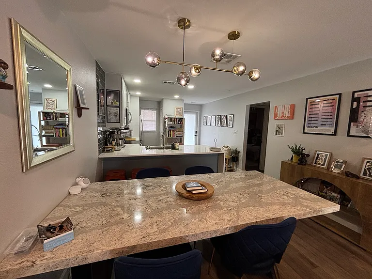 Granite dining table sits eight. Overhead lighting with energy efficient controls