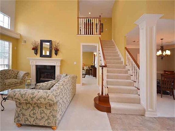 The brightness of the natural light continues into the two story formal living room.